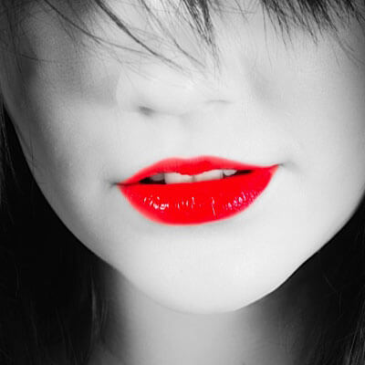 black and white picture of a woman with bright red lips