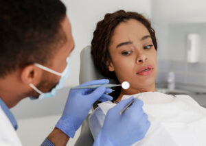 Dentist examining a patient with dental anxiety, featuring a close-up of the patient expressing concern during the dental visit.